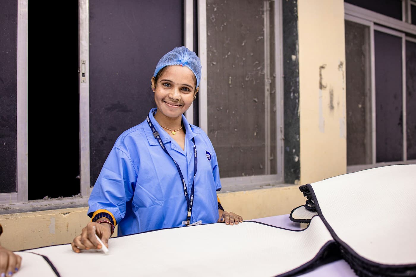 A nurse in blue scrubs at work in a hospital